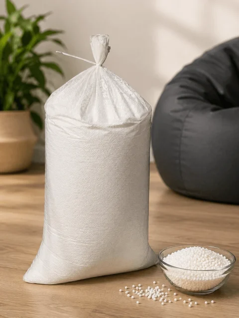 High density bean bag refill 1 kg pack filled with premium virgin EPS beans placed beside a bean bag chair.